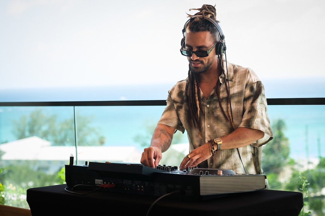 Tiago Black mixing outdoors at the DJ decks